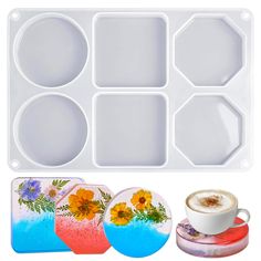 an ice tray with four different designs and a cup of coffee