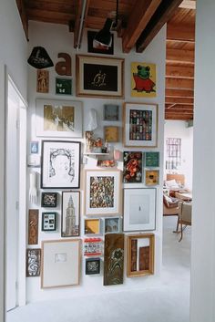 there are many framed pictures on the wall