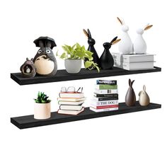 two black shelves with books and vases on them