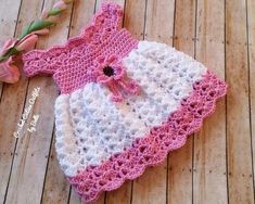 a crocheted pink and white outfit with matching hat