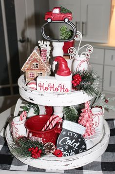 a three tiered tray with christmas decorations on it