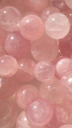 many pink bubbles floating in the air on top of each other and one is white