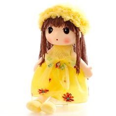 a little doll wearing a yellow dress with flowers on it's head and legs