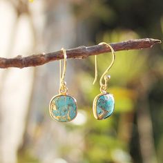 These lovely hand-crafted semi-precious stone dangle earrings feature small blue Copper Turquoise gemstone surrounded by gold electroplating. They have been lovingly made with 24K gold metal & earring posts. Stone: Copper Turquoise Colour: Blue or Green Stone Size: Square - 1cm x 1cm, Leaf - 1.2cm x 0.9cm Metal: 18K Gold Plated Earrings Drop Length: 3cm Earrings Width: 0.9cm I can customise a design specifically to meet your needs with your favourite semi-precious stones. Ask about a custom desi Turquoise 14k Gold Filled Earrings As Gift, Turquoise Gold-plated Earrings For Gifts, Turquoise 14k Gold Filled Earrings For Gift, Gift Turquoise 14k Gold Filled Earrings, Stone Dangle Earrings, Copper Turquoise, Green Copper, Semi Precious Stone, Metal Earrings