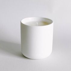 a white cup sitting on top of a table