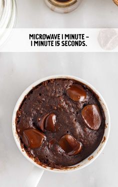 microwave chocolate cake in a white bowl with text above it that reads microwave i minute = 1 minute is seconds