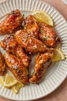 chicken wings with lemon wedges and parsley on a plate