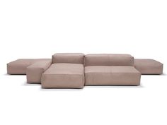 a beige sectional couch sitting on top of a white floor