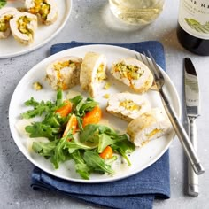 a white plate topped with food next to a bottle of wine