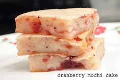 three pieces of cranberry mochi cake stacked on top of each other in front of the camera