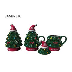 three ceramic christmas tree mugs with lights and santa's hat on them, one is