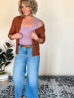 Our Nonchalant knit cardigan offers a cozy v-neck and split hem, perfect for a casual day out. The button down design adds a touch of elegance, while the copper color adds a pop to any outfit. With a fitted silhouette and a blend of 75% acrylic and 25% nylon, this cardigan is both stylish and comfortable. Amanda is wearing a small, Betty a medium. Besties: Reverse It, Flexible, Laid Back, Dress Up, LBD, Longer Days, The Staple, Hey Boots, Informal, Day Trip, Beloved Blazer Flair Dress, Fitted Silhouette, Back Dress, Copper Color, Split Hem, Store Fronts, Day Trip, Knit Cardigan, Casual Chic