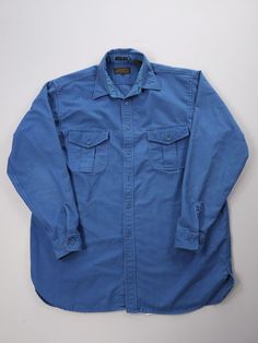 Listing: Vintage 90s Eddie Bauer Blue Chamois Cloth Cotton Button-Up Shirt XL Size on Tag: XL Flaws: Missing a couple of buttons Measurements: Please see the photos in the listing. If you require additional measurements or information about this item, feel free to send a message. Vintage Unstructured Button-up Shirt, Blue Relaxed Fit Shirt With Buttons, Blue Unstructured Shirt With Buttons, Long Sleeve Washed Blue Shirt With Snap Buttons, Blue Unstructured Shirt With Button Closure, Unstructured Blue Shirt With Button Closure, Washed Blue Collared Shirt With Snap Buttons, Blue Relaxed Fit Shirt With Buttoned Pockets, Washed Blue Long Sleeve Shirt With Buttons