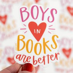 someone holding up a sticker with the words boys in books are better on it