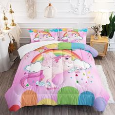 a pink bed with unicorns and clouds on it