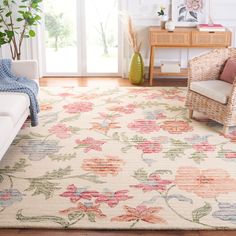 a living room area with a white couch and floral rug