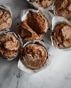 several muffins sitting on top of a marble counter