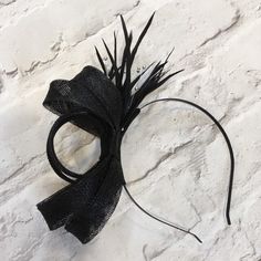 Lovely black fascinator, perfect for a wedding guest or bridesmaid headpiece. Created from black sinamay and trimmed with black biot feathers, with silver beads.   Mounted on a black metal headband. This design can also be made on a comb if required.  A beautiful addition to complete your outfit for a wedding, or day at the races  This design can be made in various colours to match your outfit. Please contact me for a custom order Elegant Black Fascinator For Party, Elegant Black Fascinator For Evening, Elegant Black Headpiece For Party, Elegant Black Evening Headpieces, Black Headband Fascinator For Party, Elegant Black Headband Fascinator, Elegant Black Fascinator For Events, Black Party Headband, Black Headband Fascinator For Evening