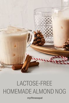 two glasses of latose - free homemade almond nog with cinnamon sticks on the side