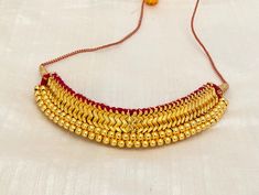 Thushi is a traditional piece of jewelry from Maharashtra. It is made by weaving small and big beads together. It is Traditional Manarashatian Jewelry. This jewelry looks very commendable and classy with traditional outfits like Nauvari, Paithani, or sarees. Highlights of this necklace ** Small Gold beads weave together. ** Adjusted with Dori in the back if you have any other questions, feel free to reach out to us Check out our other listings at: https://mdbeadworks.etsy.com JEWELLERY CARE Prot Temple Jewelry Necklaces With Latkans For Puja, Gold Fusion Style Temple Necklace For Navratri, Gold Fusion Temple Necklace For Navratri, Handmade Chandbali Temple Necklace For Puja, Traditional Yellow Gold Temple Necklace For Puja, Heavy Fusion Necklace For Puja, Traditional 22k Gold Bridal Necklace For Puja, Traditional Necklaces With Latkans For Diwali, Navratri Puja Necklaces With Latkans