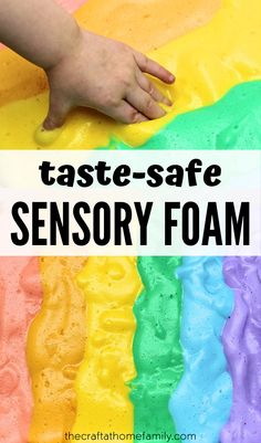 a rainbow cake with the words taste safe sensory foam on it and a hand reaching for