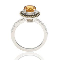 Suzy Levian Round-Cut Citrine, Yellow Sapphire and White Topaz Ring  This chic citrine, yellow sapphire and white topaz ring carries a message from designer Suzy Levian in the form of her signature "hidden diamond," set inside the shank. By creating jewelry that is beautiful inside and out, she hopes to empower women to discover their own inner strength, power and beauty.         Approx. 0.43"L x 0.43"W x 0.31"H; shank 0.08"W     Stamped .925     Sterling silver ring has as round-cut citrine sol Elegant Citrine Diamond Ring With Halo Setting, Luxury Yellow Halo Jewelry, Elegant Topaz Halo Ring, Elegant Yellow Halo Ring, Formal Yellow Halo Ring, Elegant Citrine Jewelry With Halo Setting, Luxury Topaz Rings With Halo Setting, Luxury Citrine Rings With Halo Setting, Luxury Topaz Ring With Halo Design