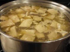 a pot filled with food sitting on top of a stove