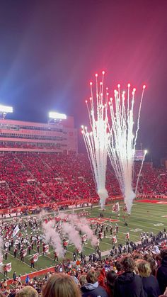 a football stadium filled with lots of people watching fireworks