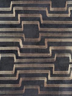 an old black and brown rug with lines on it