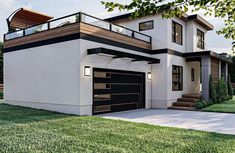 a two story house with an attached deck and garage on the second floor is shown