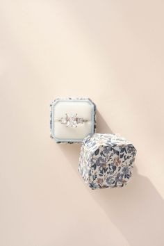 two jewelry boxes sitting next to each other