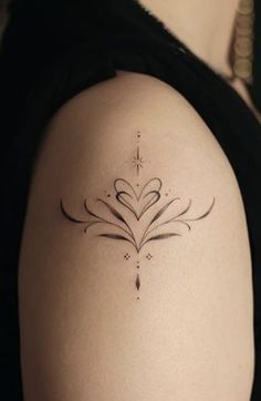 a woman with a tattoo on her arm is looking down at the ground and has an arrow