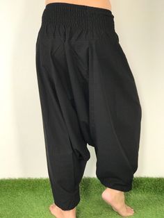 "These super soft rayon baggy unisex harem pants have the \"flow\", perfect of yoga or just a cool strolling. Comfort and character are what these pants are all about. They have the traditional sarong look & feel but a lot more practical when it comes to activity like yoga. As a bonus, they are convertible! Just pull them up and you get yourself a cute jumpsuit in a flash. Together with elastic cuff legs, you can wear them short or long. The pants have smock waist (wide bang elastic) with no Baggy Ankle-length Harem Yoga Pants, Cotton Drop Crotch Harem Pants For Yoga, Traditional Relaxed Fit Wide Leg Harem Pants, Black Cotton Harem Yoga Pants, Traditional Relaxed Fit Harem Pants For Yoga, Black Cotton Harem Pants For Yoga, Baggy Wide Leg Harem Pants For Meditation, Baggy Wide-leg Harem Pants For Meditation, Traditional Wide Leg Harem Pants For Meditation