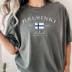 "Helsinki - Best Comfort Colors® 1717 Shirt - Helsinki Finland Tshirt Capture the essence of Helsinki, Finland, with my elegant \"Helsinki Finland\" t-shirt, beautifully showcasing the country's flag emblem.  Crafted in a polished font, this tee radiates sophistication. Made from the popular and trendy Comfort Colors 1717 style brand, it boasts a slightly oversized and relaxed fit, ensuring both comfort and style. Embrace your Scandinavian roots and cultural adoration with this unique piece.  Wh Soft-washed Crew Neck T-shirt For Fans, Relaxed Fit Fan Apparel Crew Neck Shirt, Soft-washed Crew Neck T-shirt For Fan Apparel, Soft-washed Crew Neck Fan T-shirt, Soft-washed T-shirt For Fan Merchandise With Short Sleeves, Fan Apparel Soft-washed Crew Neck T-shirt, Soft-washed Short Sleeve T-shirt For Fan Merchandise, White Custom Print T-shirt For Adventure, Vikings Shirt