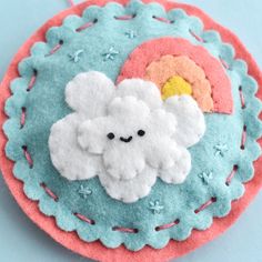 there is a felt brooch with clouds on it