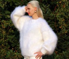 "FUZZY HAND KNITTED MOHAIR SWEATER by SuperTanya Hand knitted with love and care for your comfort and complete satisfaction. Its clear and plain design makes this warm and breathable fashion cloth suitable for any occasion. Wherever you are, the lovely white color will make you feel like a star. At office, shopping center or at home - you will be the \"only one\", around. With the crew neckline style you will fully comply with the fashion trends for the upcoming season. This premium quality, han Elegant Oversized White Sweater, Cozy Soft Knit White Sweater, White Cozy Soft Knit Sweater, Cozy White Soft Knit Sweater, Oversized White Soft Sweater, White Knitted Crew Neck Sweater, White Soft Knit Winter Sweater, White Soft Knit Cozy Fit Sweater, White Soft Knit Sweater With Cozy Fit