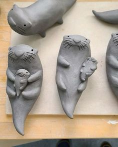 four clay animals are sitting on a table