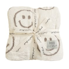 a towel wrapped in white with a smiley face drawn on it