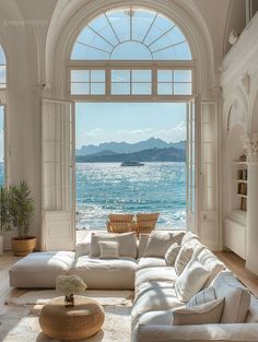 a living room with an arched window overlooking the ocean