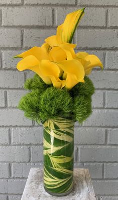 a vase filled with yellow flowers on top of a table