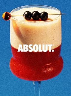 an advertisement for absolut on the side of a wine glass with olives in it