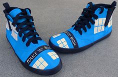 a pair of blue sneakers with police logos on them sitting on the ground next to each other