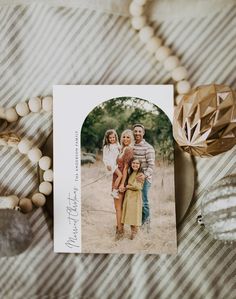 a card with an image of two people and a child on it next to some beads