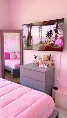 a bedroom with pink walls and furniture in the room, including a dresser that has bottles on it