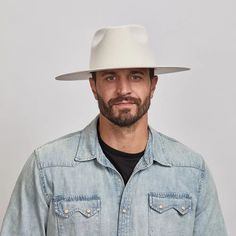 Man with a beard wearing a White Rancher Hat and a denim jacket over a black shirt. Modern White Hat With Curved Brim, Classic White Felt Hat With Short Brim, Classic White Hat With Flat Crown, Classic White Flat Crown Hat, American Hat Makers, Leather Cowboy Hats, Rancher Hat, Wide Brim Fedora, Felt Fedora