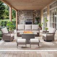 an outdoor patio with furniture and fire pit