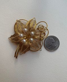 This listing is for the Midcentury Orchid Gold tone metal and faux pearl brooch that you see featured in photos. This pin is gold plated metal with assortment of white faux pearl accents. This pin/brooch is in nice used condition. Please take a look at photos, this is the actual brooch you will receive in the order. Please follow our shop link for more vintage! https://www.etsy.com/shop/CandilandArt Gold Flower Pins For Wedding, Gold Clip-on Costume Jewelry Brooch, Gold Clip-on Brooch For Wedding, Gold Costume Jewelry Pins For Wedding, Gold Clip-on Brooches For Wedding, Gold Orchid, Mannequin Art, Pearl Brooch, Orchid Flower