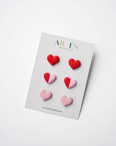 three hearts are placed on top of a white paper with the word arn written in it