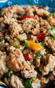 a blue bowl filled with meat and vegetables