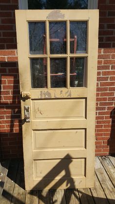 an old wooden door with glass panes on it